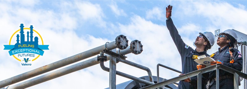On the right, two Valero employees wearing full PPE stand on equipment and look up. On the left, we see a logo for Fueling Exceptional Futures features a silhouette of a refinery in blue, surrounded by a thin yellow circle. Within the circle is a blue banner with blue, yellow and white text that reads FUELING EXCEPTIONAL FUTURES. Beneath this is the Valero logo, accompanied by the Valero company name.